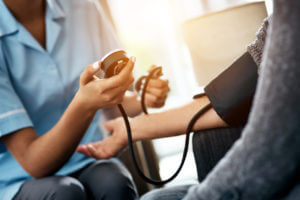 Cropped shot of a senior woman getting her blood pressure measured during a checkup with a nurse