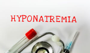 Hyponatremia is a medical condition characterized by low sodium levels in the blood, illustrated with a test tube, syringe, and stethoscope.