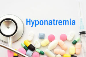 An image of a stethoscope and medications used for the treatment of hyponatremia.